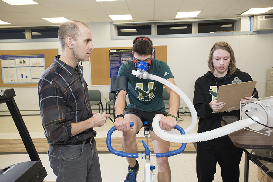 Exercise Science Coordinator and Associate Professor Jay Polsgrove, Ph.D., works with students in the Kinesiology Lab.