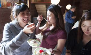 Korean students laughing and eating ice cream