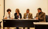 Members seated signing transfer agreements