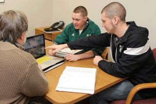 picture of students helping a local resident with taxes