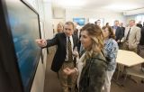 onlookers observe large interactive touchscreen in Ronan Center