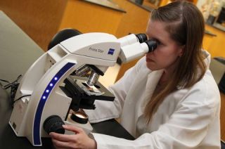 student looking in a microscope