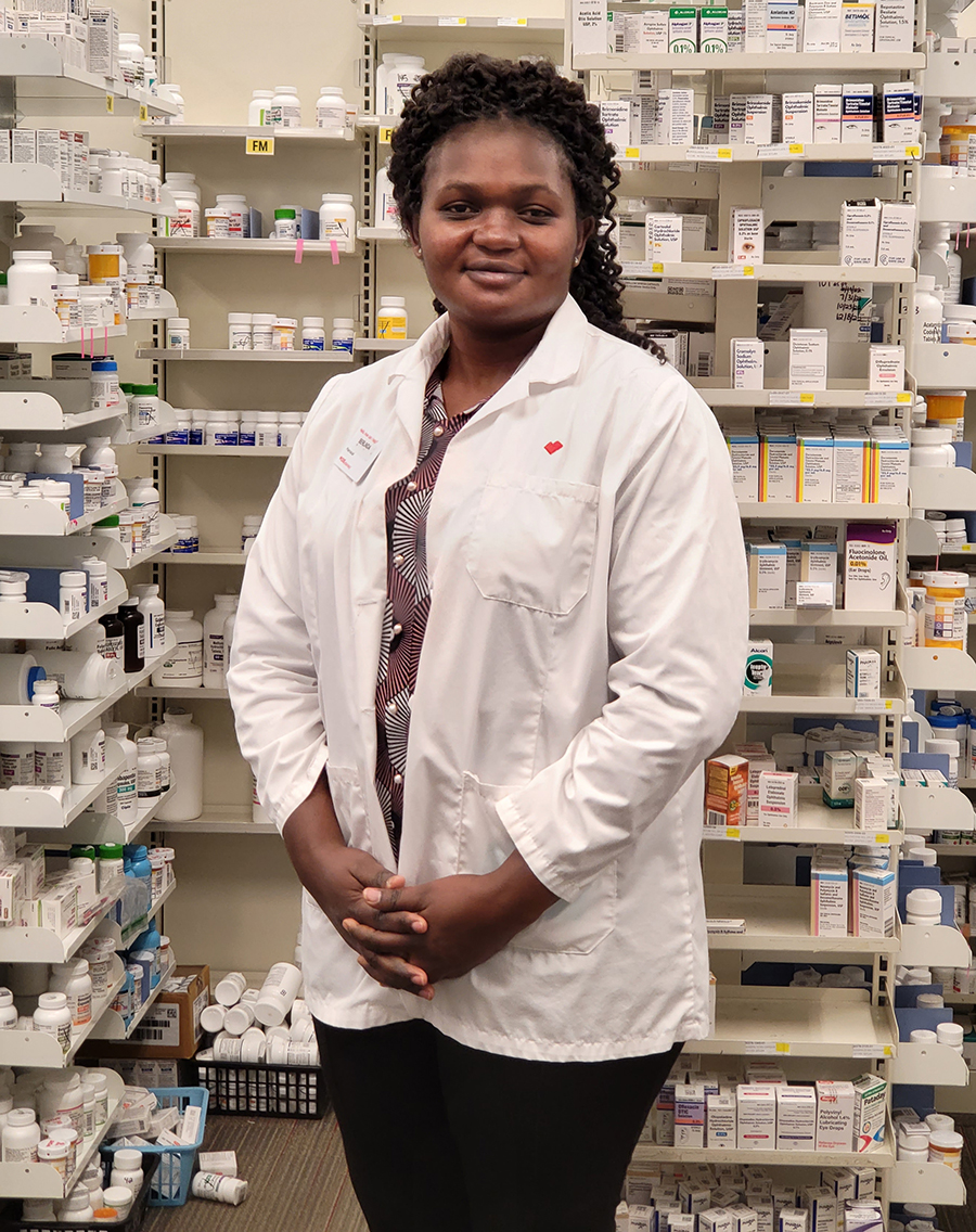 Photo of Berlinda Wongli, pharmacist and Husson University Graduate standing in a pharmacy setting, 