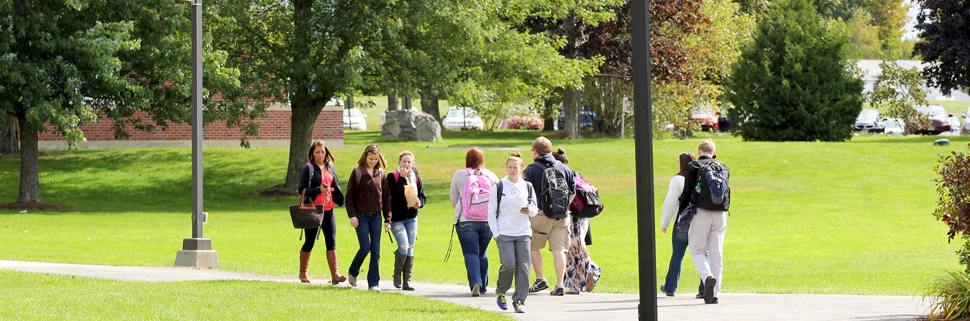 Students walking on campus at Husson University