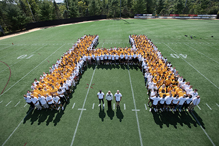 students form an H on the Husson football field