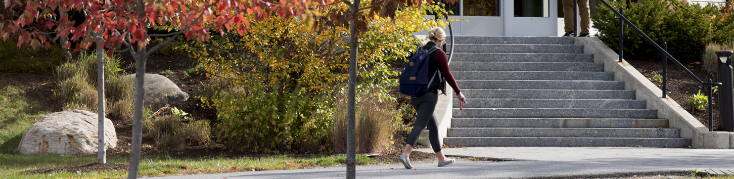 Student walking in front of the Darling Living Learning Center