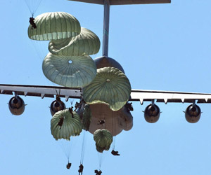 An image of soldiers dropping out of a place.