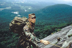 An image of a soldier climbing up a mountain.