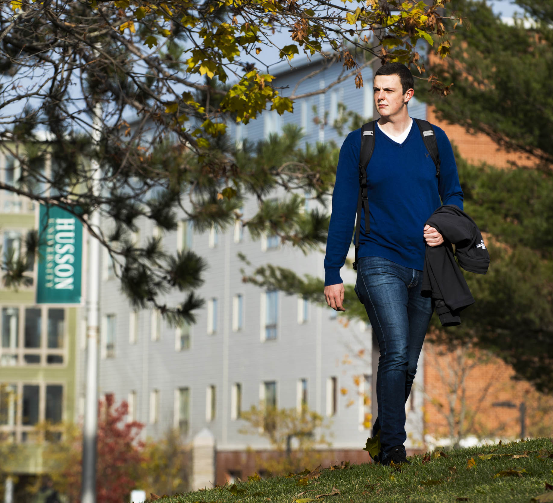 A student walks across the Husson University Campus