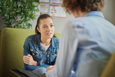 young woman receives counseling in an office setting