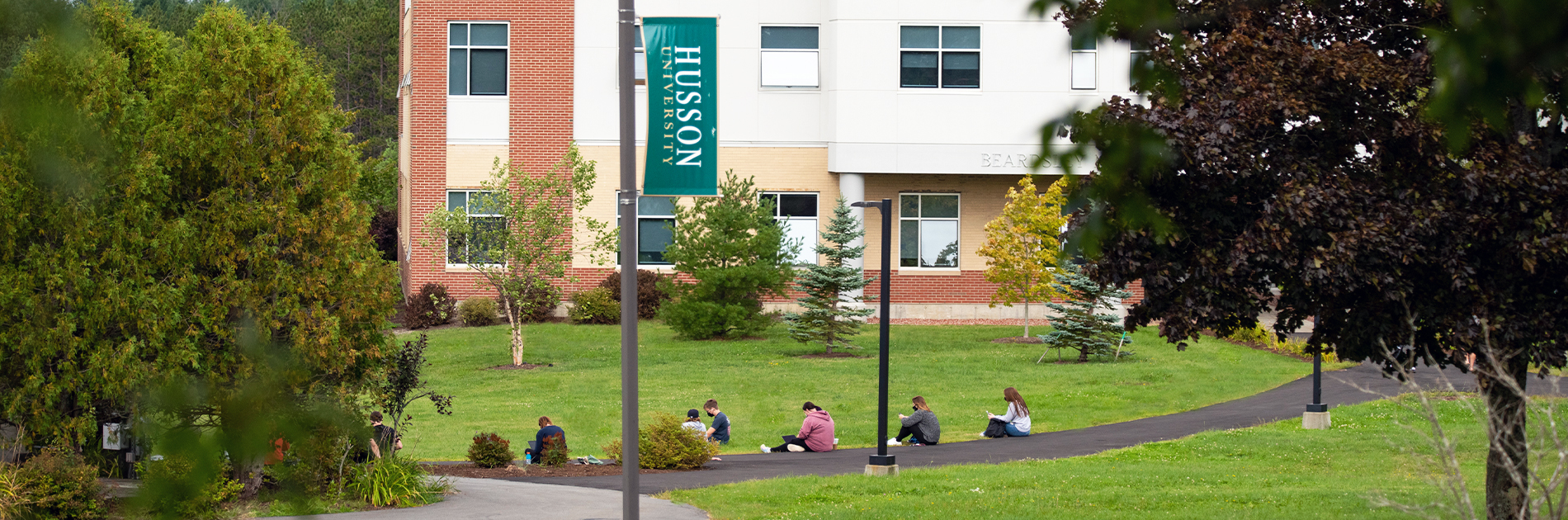 Students taking picture on campus of Husson University