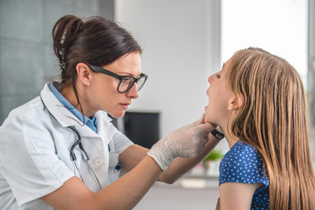 nurse working with a young female patient