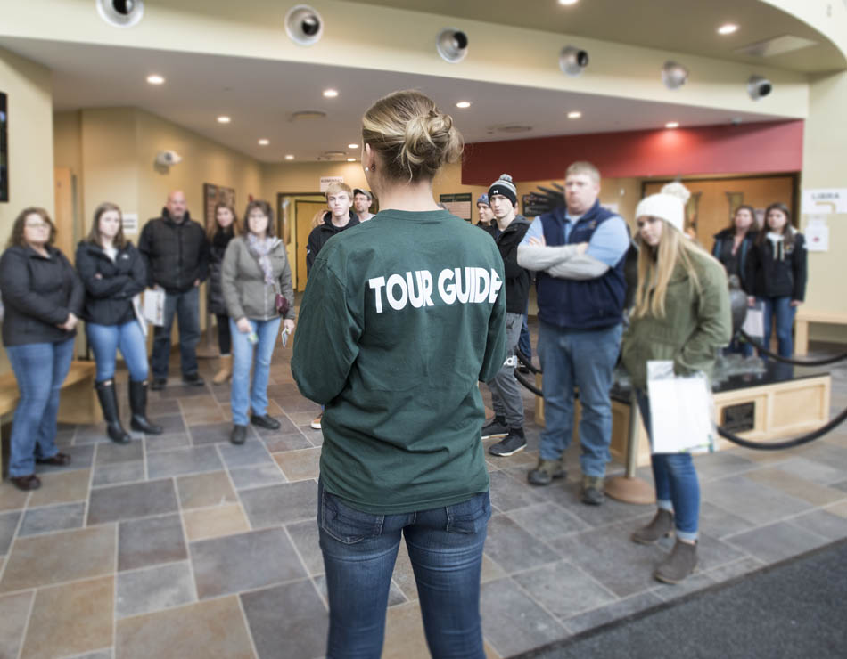 tour guide speaking to a crowd of prospective students and parents