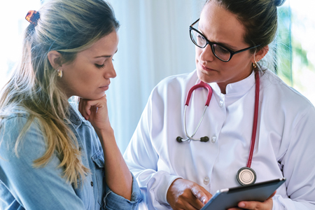 Nurse practitioner assisting with patient