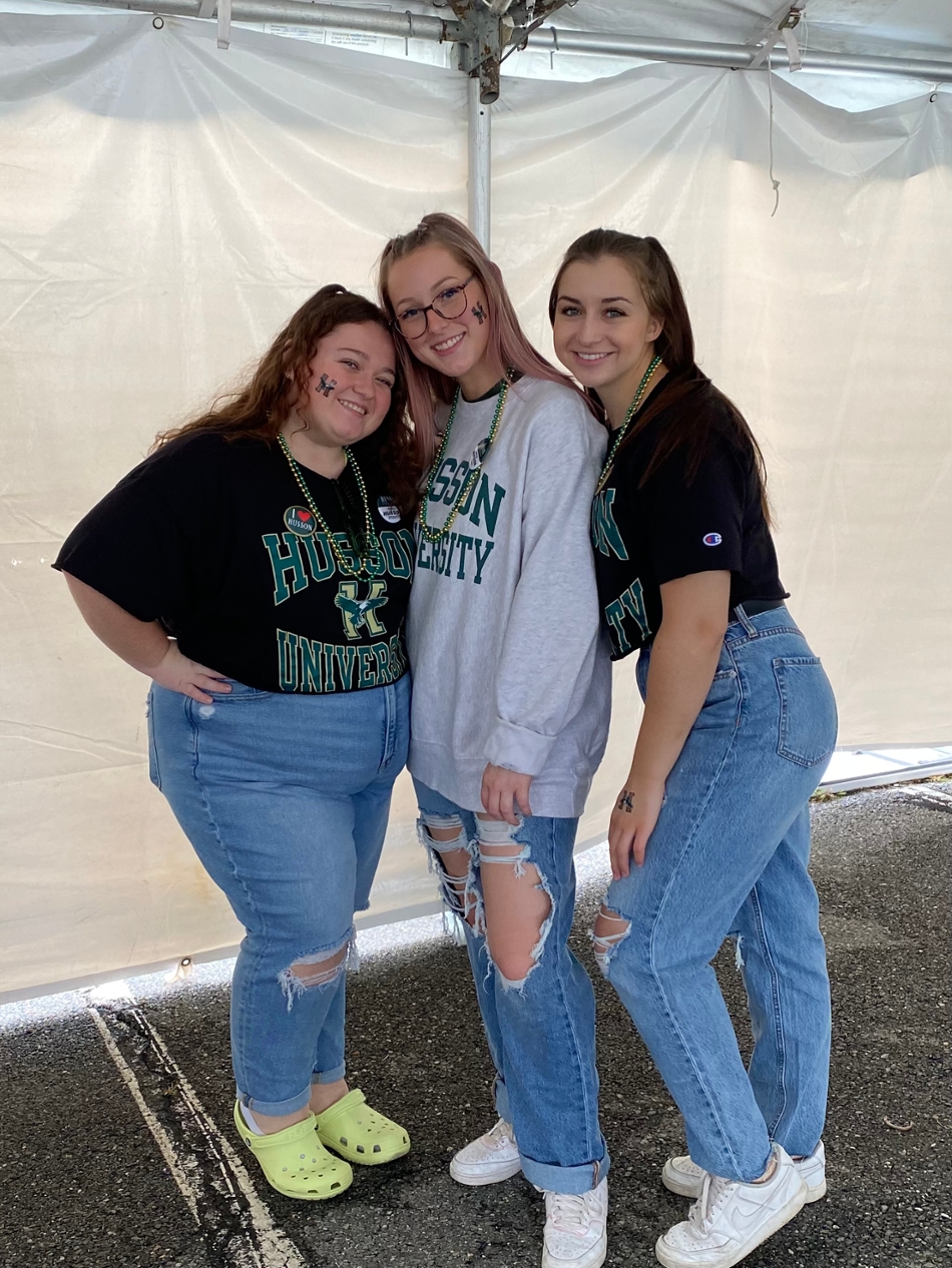 Burnell and friends wearing Husson gear during Homecoming