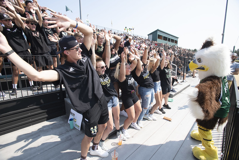 Baldwin in the stands with students cheering