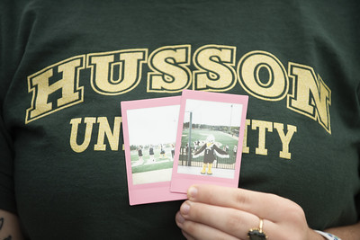 Student holding smaller photos of Baldwin