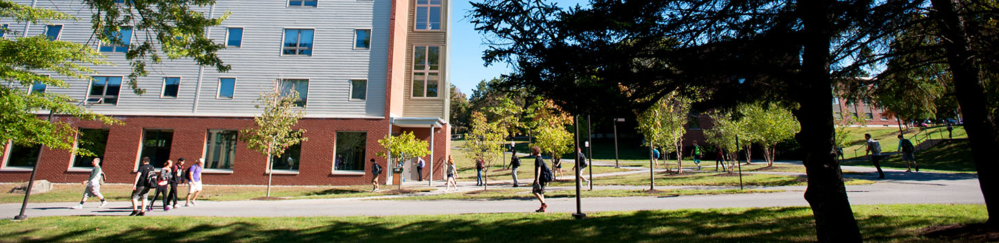 Student walking in front of the Darling Living Learning Center