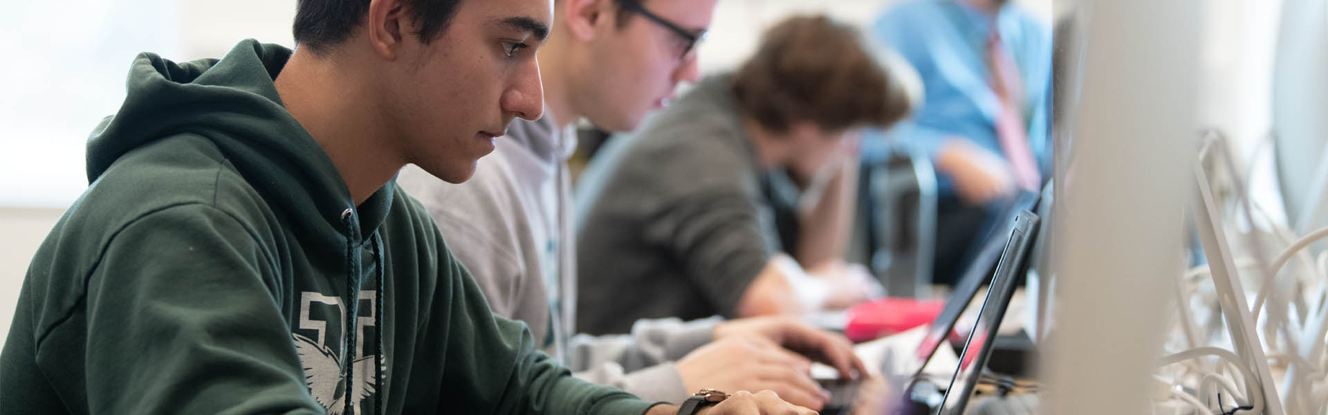 A student works on a computer in a lab in Harold Alfond Hall