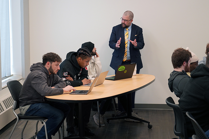 Students attend class with a faculty member