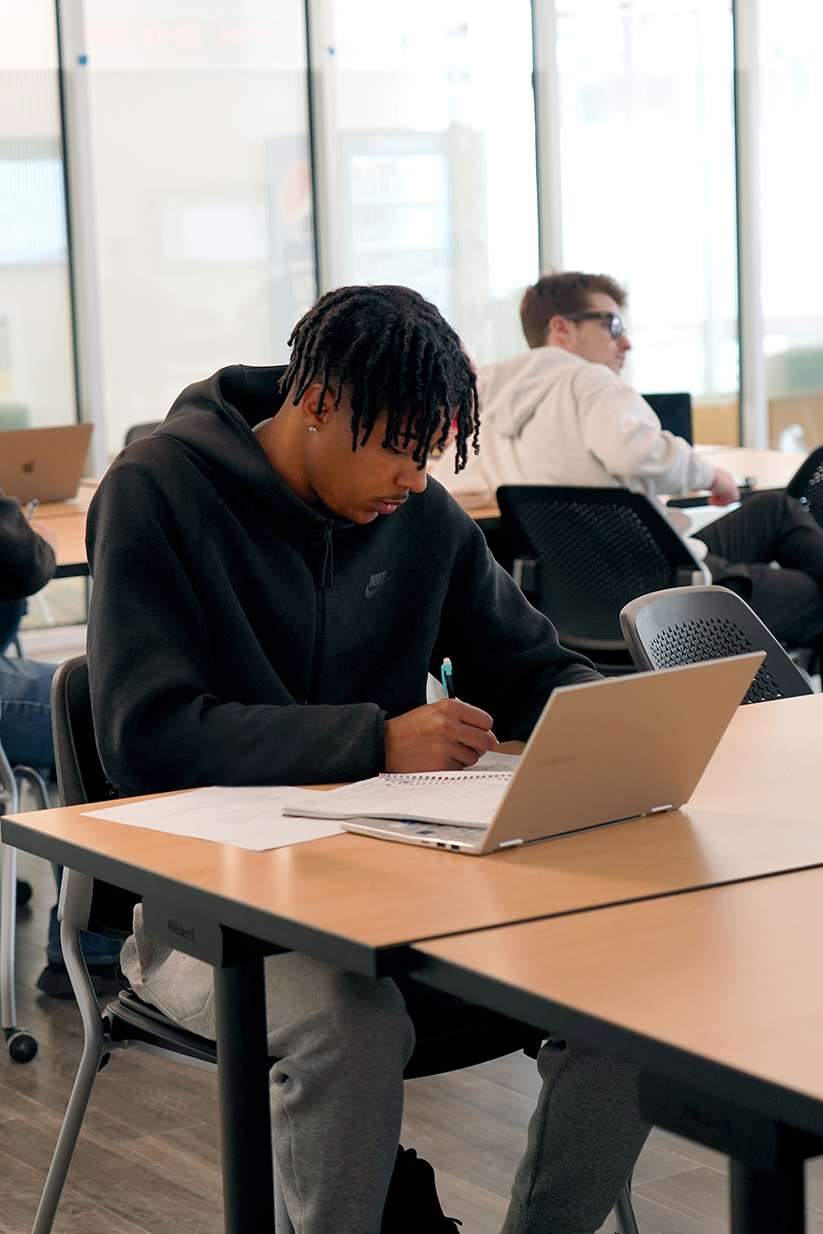 Students sitting in a class listening to a lecture at Husson University