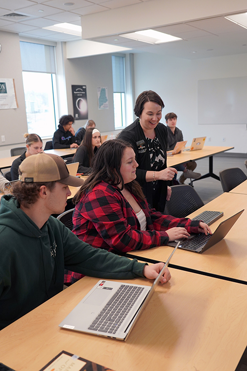 Students sitting in a class listening to a lecture at Husson University