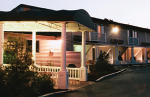 The exterior of a hotel at dusk.