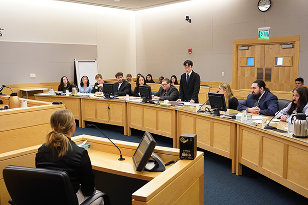 Students participate in a mock trial in a court room