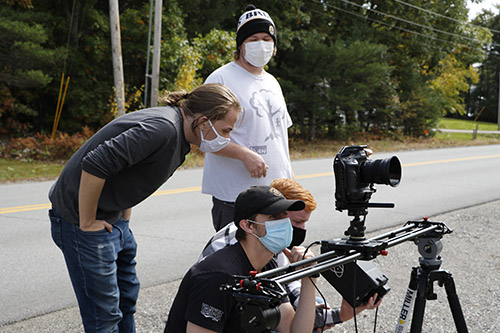 New England School of Communications tudents work on camera equipment on a film location site