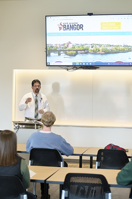 faculty work with students during a class lecture