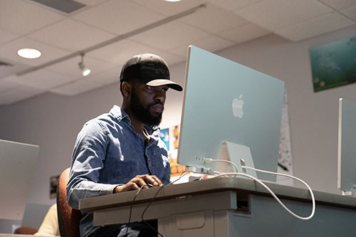 A student works on a computer in a lab