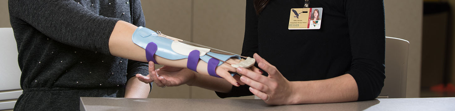 Occupational Therapy students work with a sling on an arm