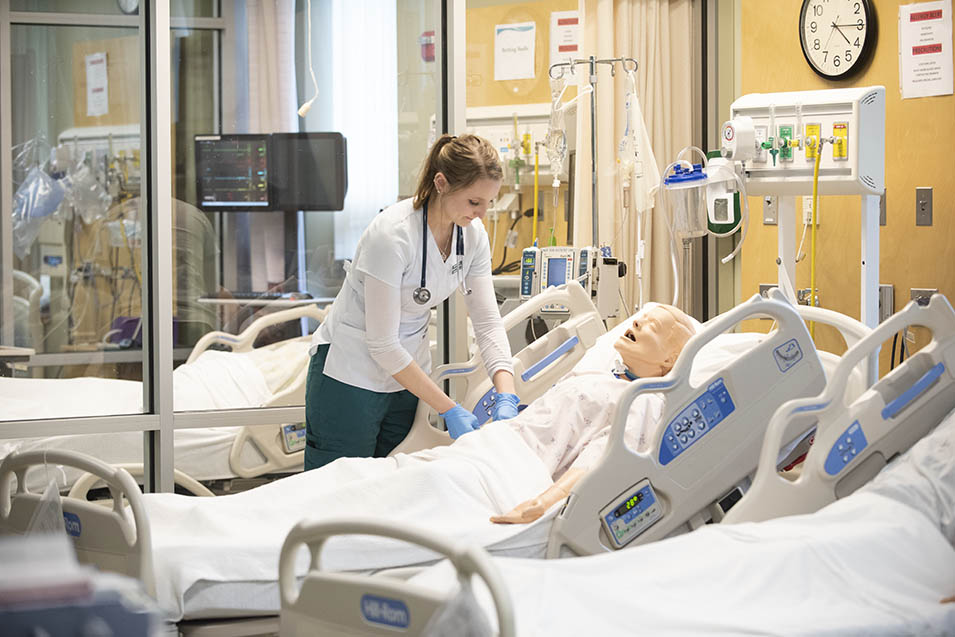 Students work in a nursing sim lab
