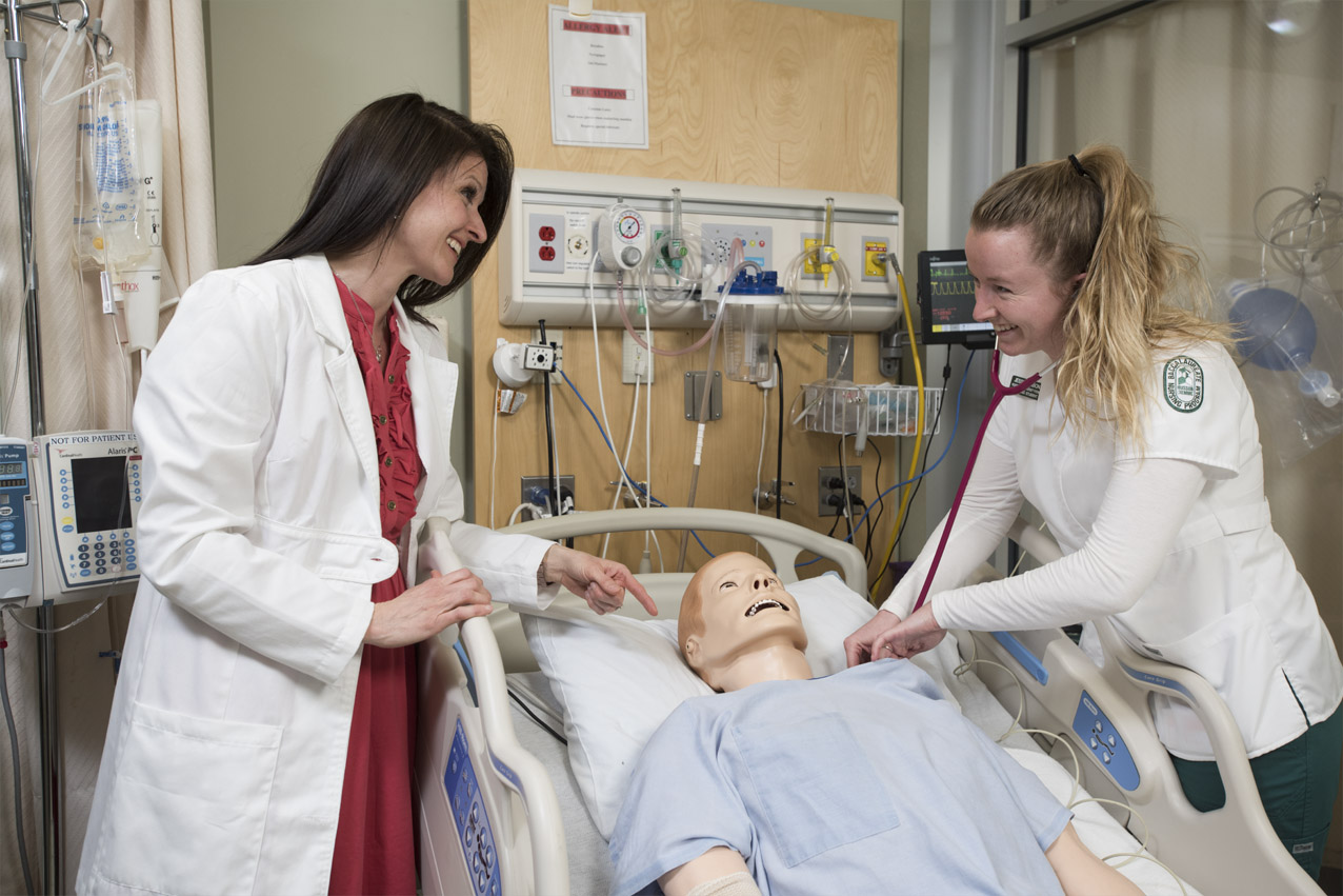 A laptop and simulation dummy is used by faculty and students in the Sim Laboratories