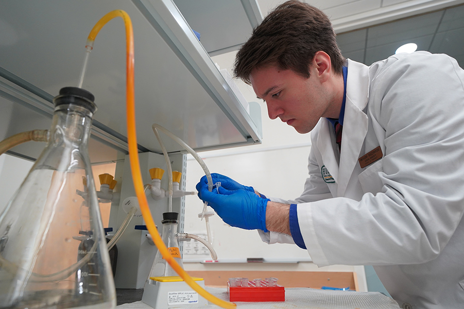 A pharmacy student works in a lab
