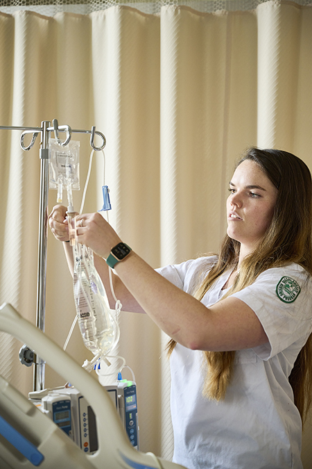 A nursing student working in a sim lab