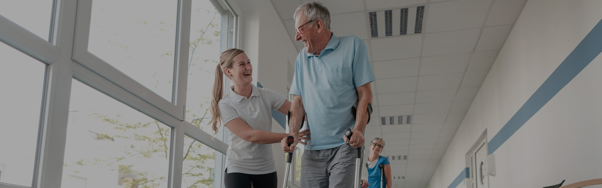 OTD professional helps elderly patient to use a walker during an occupational therapy session.