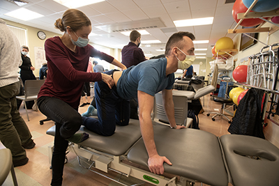 Doctor of Physical Therapy (DPT) students practice physical therapy techniques in a class while pursuing their physical therapy degree.