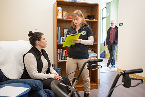 Occupational Therapy students with in a simulation lab with faculty looking on
