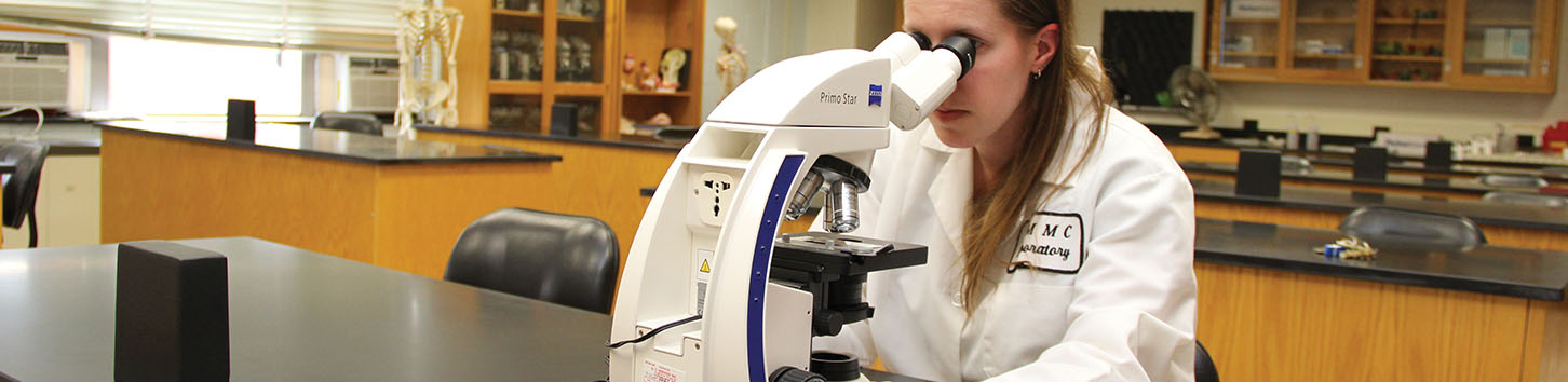 Student working on microscope
