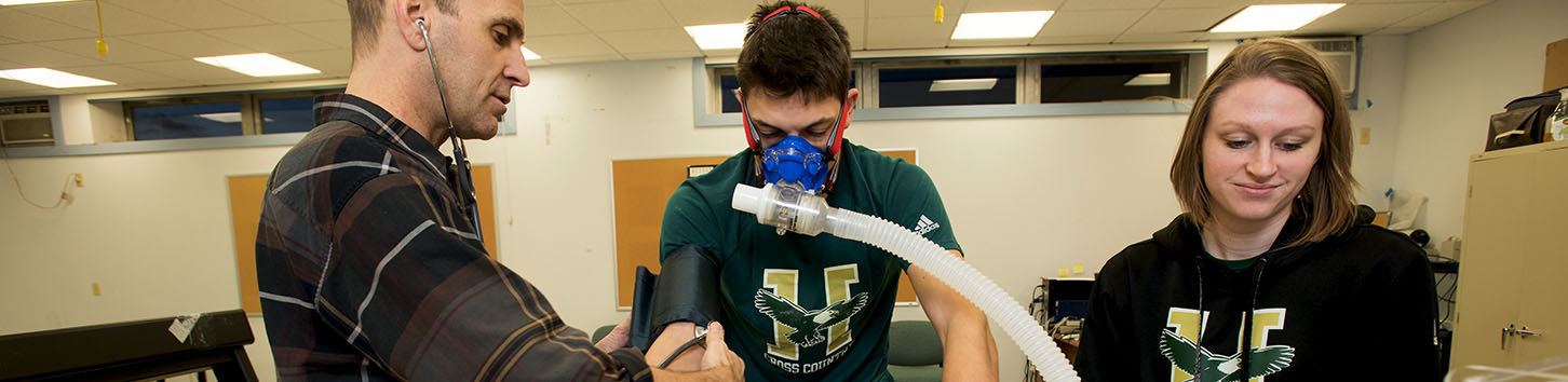 Students and faculty work on exercise science equipment