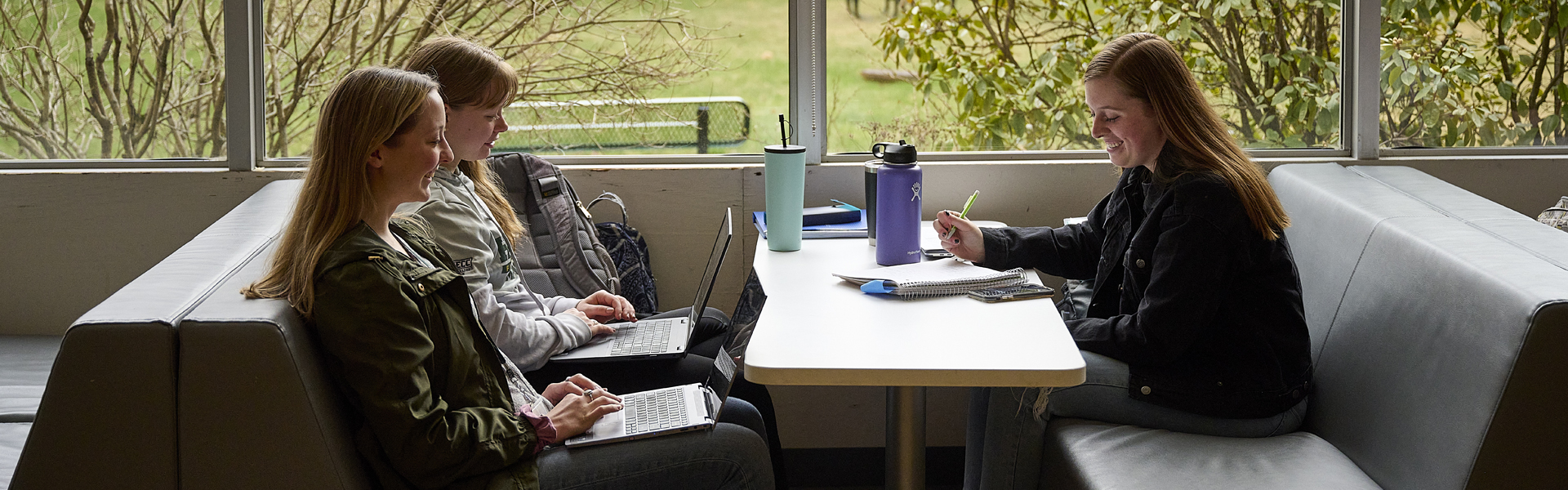 A student studies on campus of Husson University