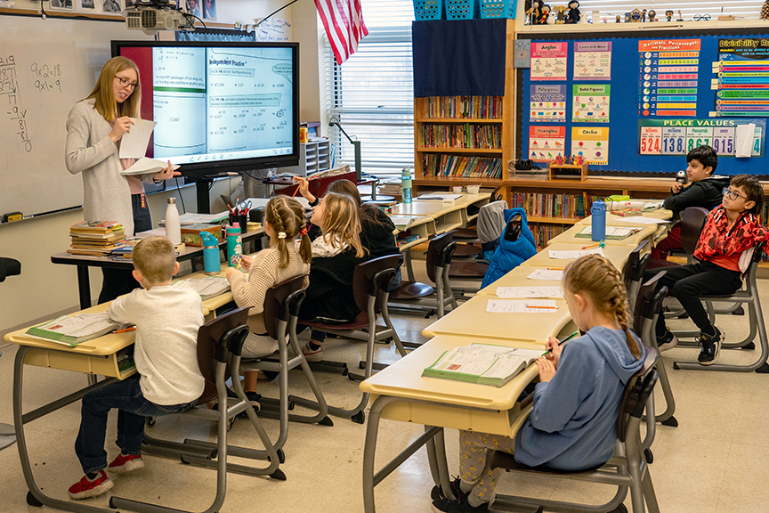 A student teacher works in a classroom at a local elementary school