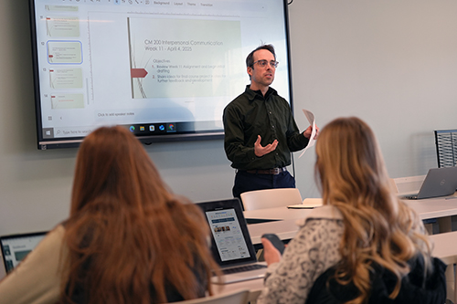Students sitting in a class listening to a lecture at Husson University