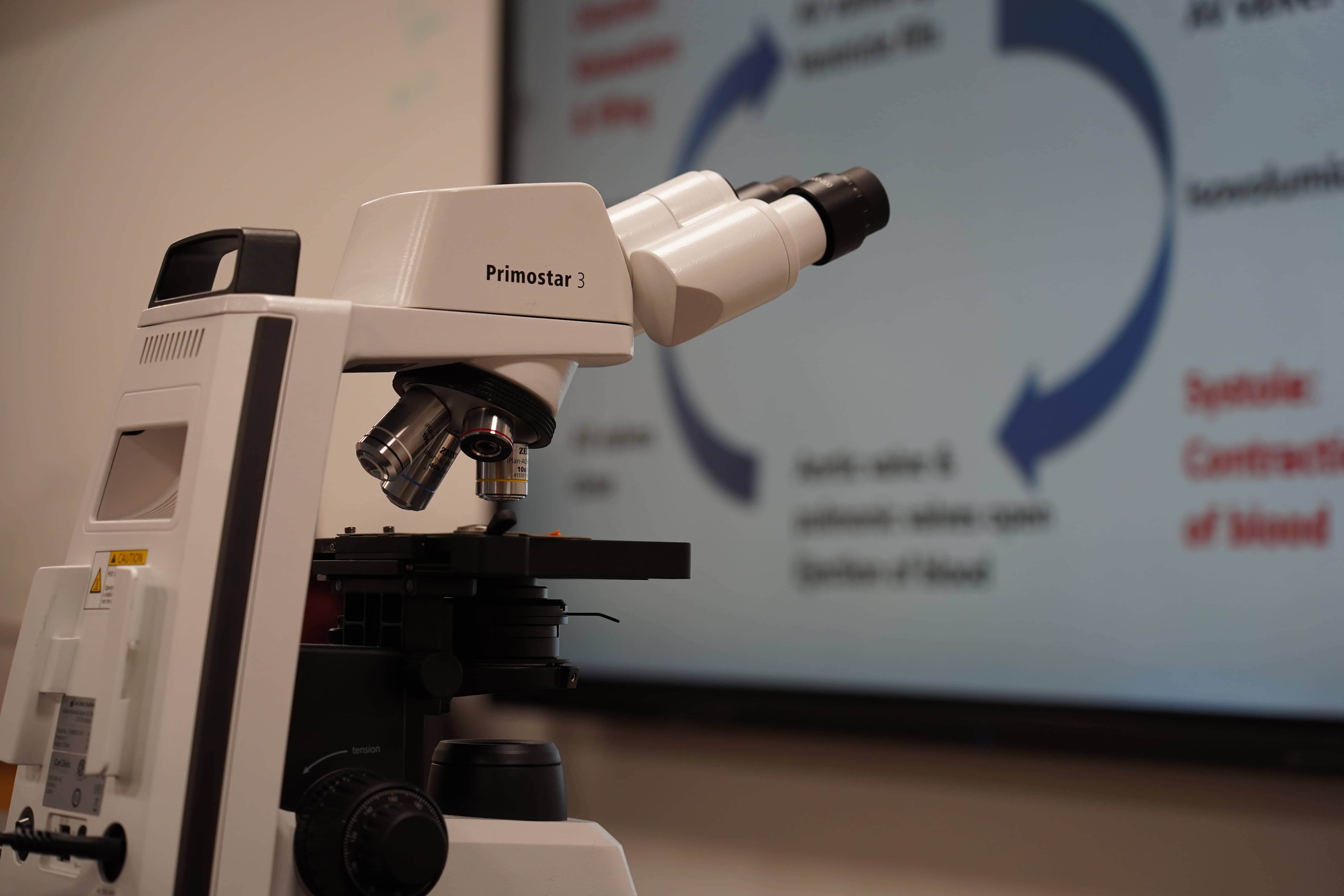 Close up of a microscope in a science lab.