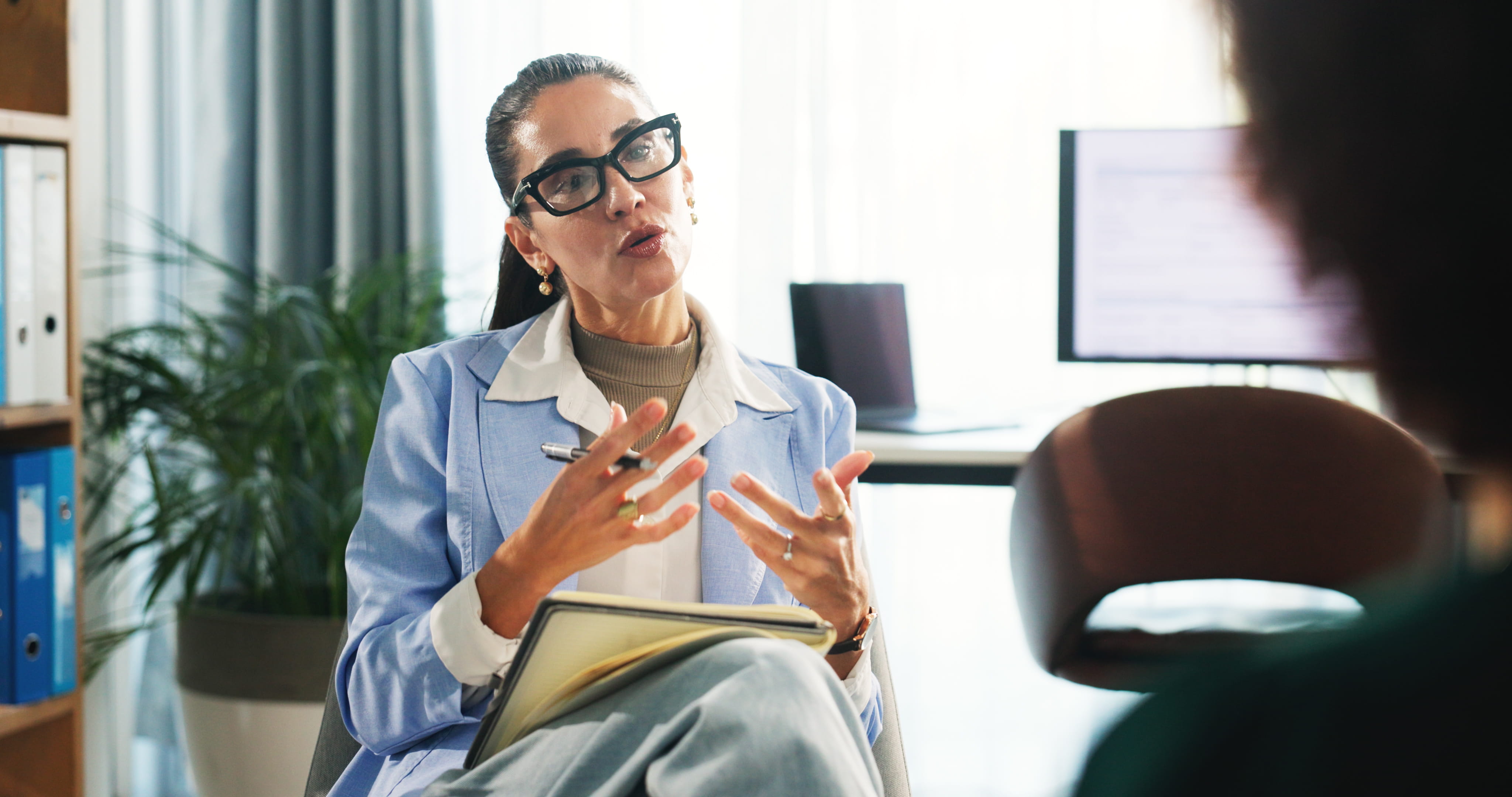 Female therapist speaking to a patient.