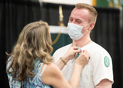 Dan Egan receiving nursing pin