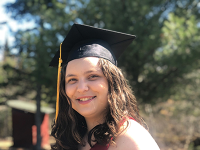 Kim Flanagan poses in her graduation cap