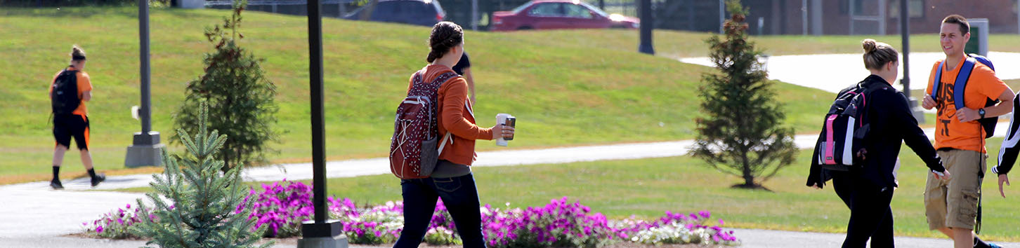 Students walking on campus at Husson University