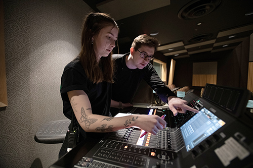 Students  work on an audio console in the Gracie Theatre